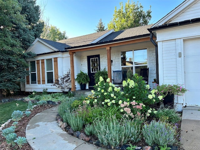 ranch-style home featuring covered porch and a garage