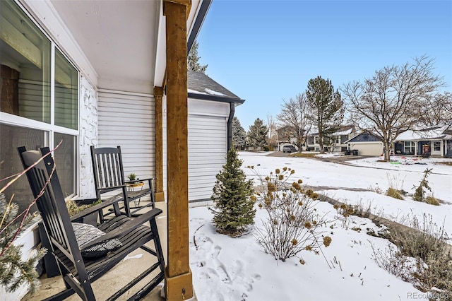 yard covered in snow featuring covered porch