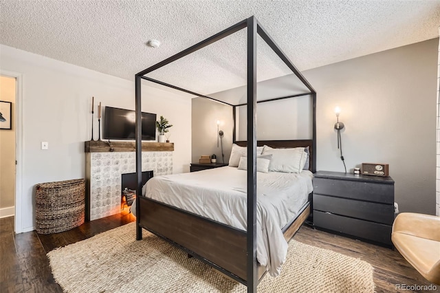 bedroom featuring hardwood / wood-style flooring and a textured ceiling