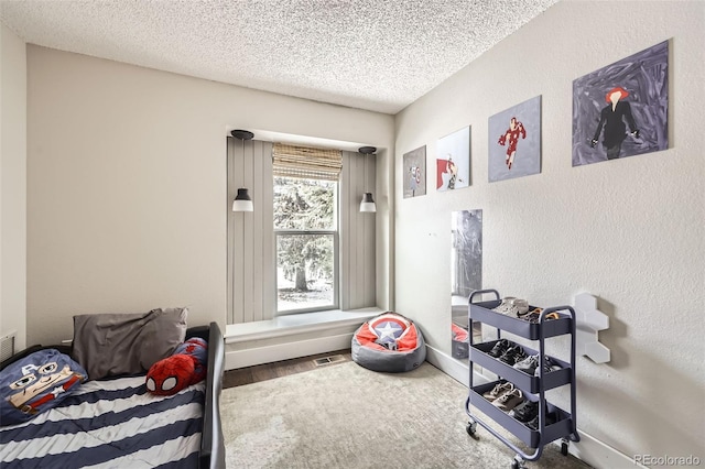 interior space with hardwood / wood-style flooring and a textured ceiling