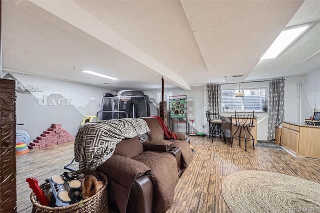 living room featuring hardwood / wood-style flooring and beamed ceiling