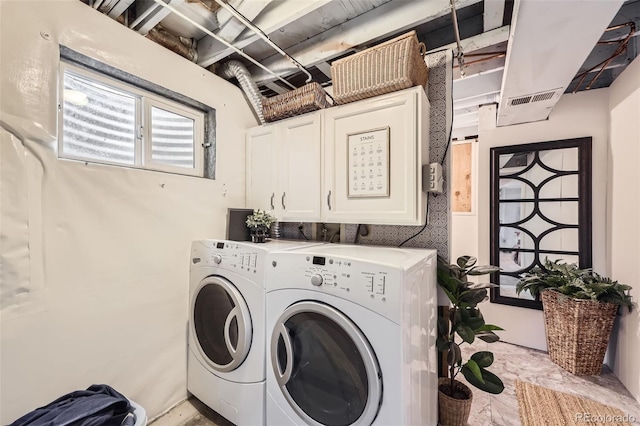 washroom featuring cabinets and washing machine and clothes dryer