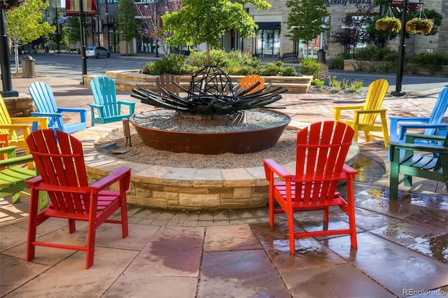 view of property's community with a patio area and an outdoor fire pit