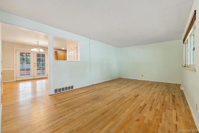 8137 Vanguard Dr, Denver, CO 80221 - unfurnished room with a chandelier, light wood-style floors, and baseboards