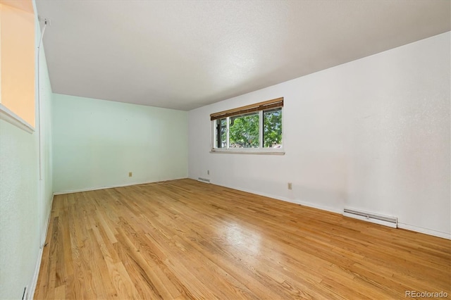8137 Vanguard Dr, Denver, CO 80221 - empty room featuring wood finished floors and a baseboard heating unit