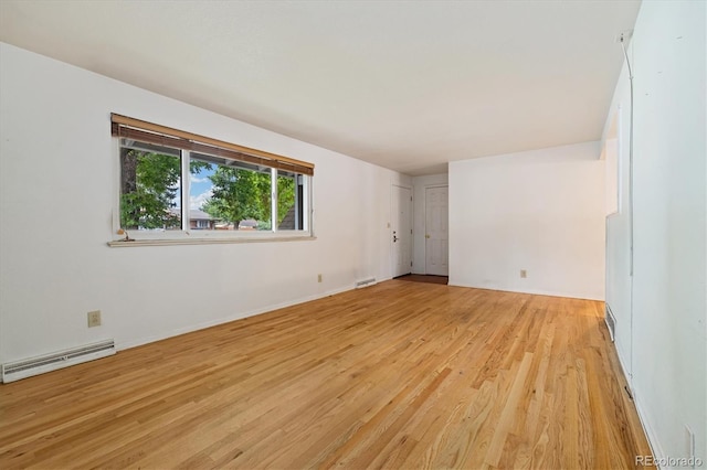 8137 Vanguard Dr, Denver, CO 80221 - unfurnished room with baseboard heating, light wood-style floors, and baseboards