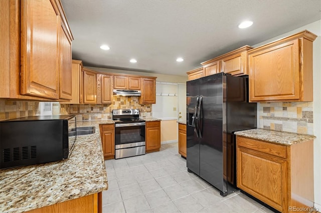 8137 Vanguard Dr, Denver, CO 80221 - kitchen with electric stove, fridge with ice dispenser, black microwave, under cabinet range hood, and decorative backsplash