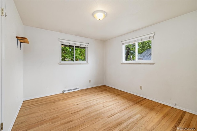 8137 Vanguard Dr, Denver, CO 80221 - unfurnished room with a baseboard radiator, light wood-style flooring, and baseboards
