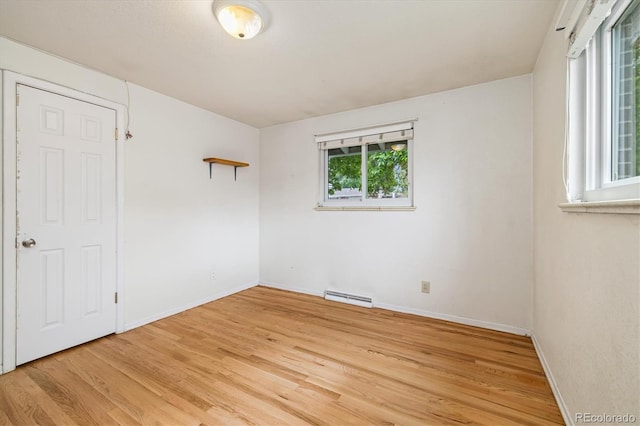 8137 Vanguard Dr, Denver, CO 80221 - empty room featuring baseboard heating, light wood-style floors, and baseboards