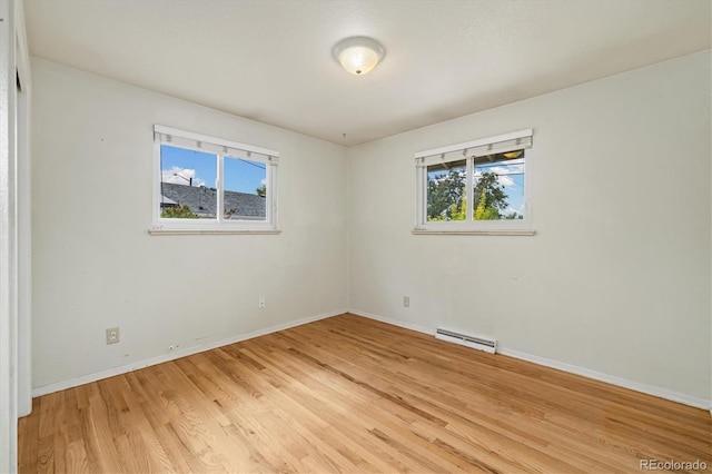 8137 Vanguard Dr, Denver, CO 80221 - empty room featuring a baseboard radiator, healthy amount of natural light, light wood finished floors, and baseboards