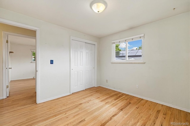 8137 Vanguard Dr, Denver, CO 80221 - unfurnished bedroom featuring light wood-style flooring, baseboards, and a closet