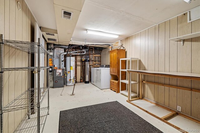 8137 Vanguard Dr, Denver, CO 80221 - finished below grade area featuring independent washer and dryer, gas water heater, heating unit, and wooden walls