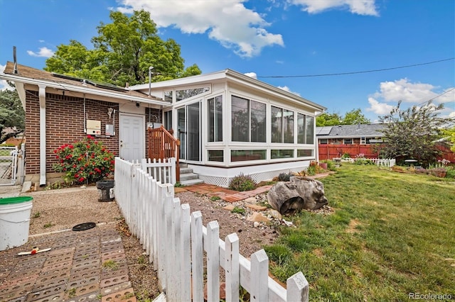 8137 Vanguard Dr, Denver, CO 80221 - view of front of property featuring a sunroom and brick siding