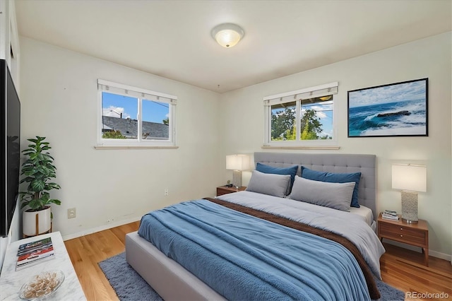 8137 Vanguard Dr, Denver, CO 80221 - bedroom with multiple windows, light wood finished floors, and baseboards