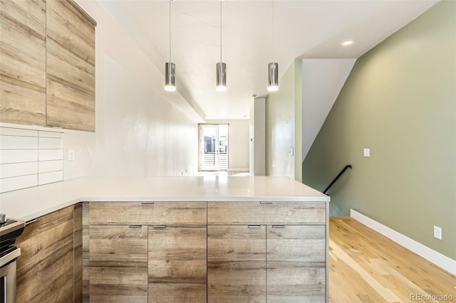 kitchen with a peninsula, modern cabinets, and light countertops