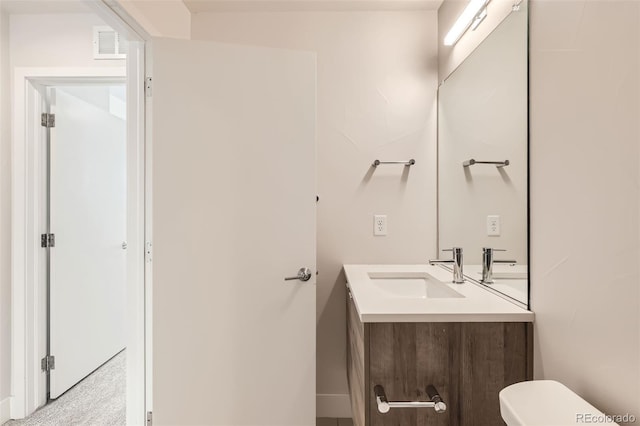 bathroom featuring visible vents, vanity, and toilet