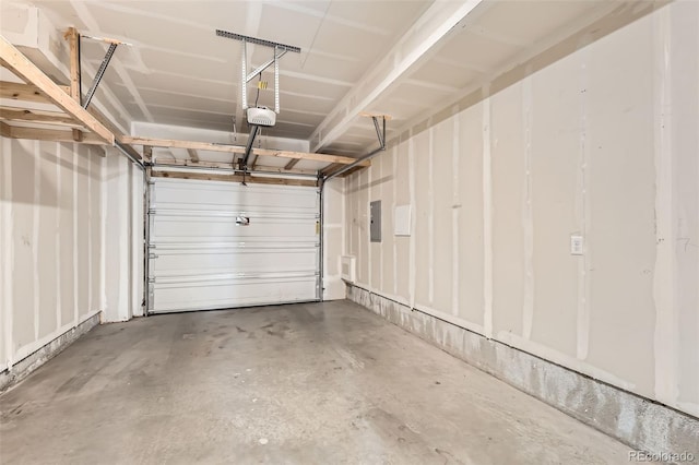 garage with electric panel and a garage door opener