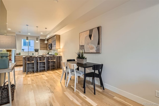 1810 Irving St Unit 4, Denver, CO 80204 - dining area featuring baseboards, light wood-style floors, and recessed lighting