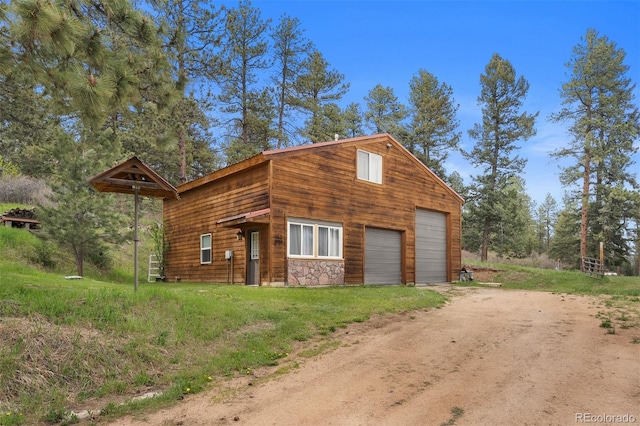 245 N County Highway 67, Sedalia, CO 80135 - view of front of property with dirt driveway and a garage