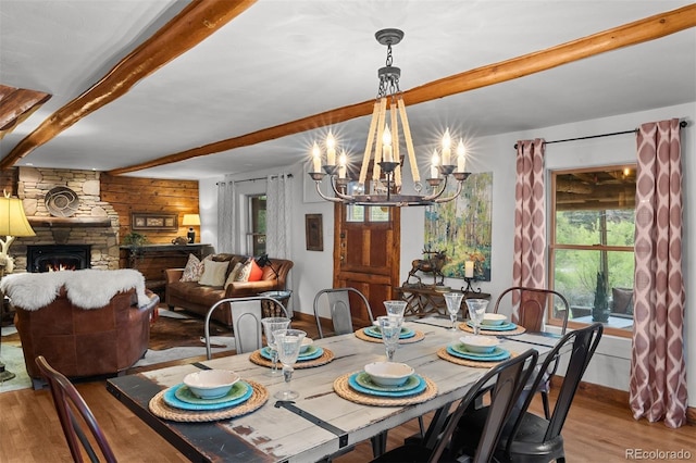 245 N County Highway 67, Sedalia, CO 80135 - dining room featuring wood finished floors, beam ceiling, a chandelier, and a fireplace