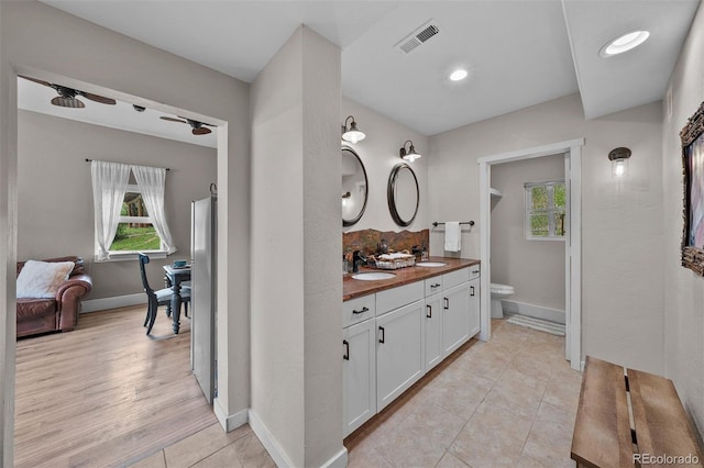 245 N County Highway 67, Sedalia, CO 80135 - bathroom featuring double vanity, healthy amount of natural light, tile patterned floors, recessed lighting, and a ceiling fan