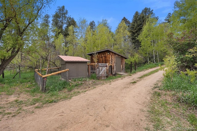 245 N County Highway 67, Sedalia, CO 80135 - view of shed featuring dirt driveway and a view of trees