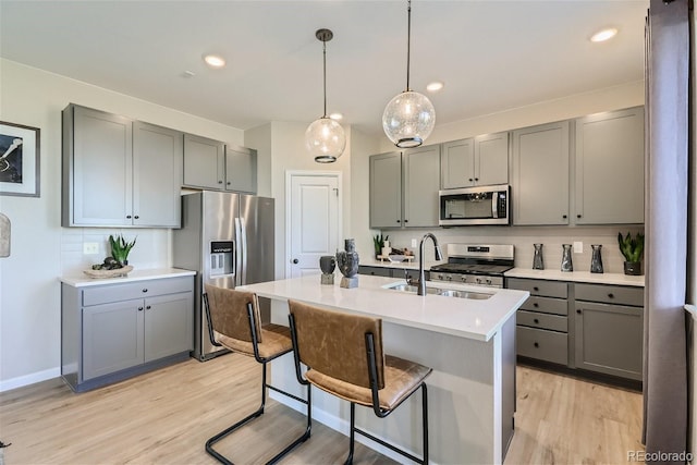 kitchen featuring tasteful backsplash, light hardwood / wood-style flooring, and stainless steel appliances