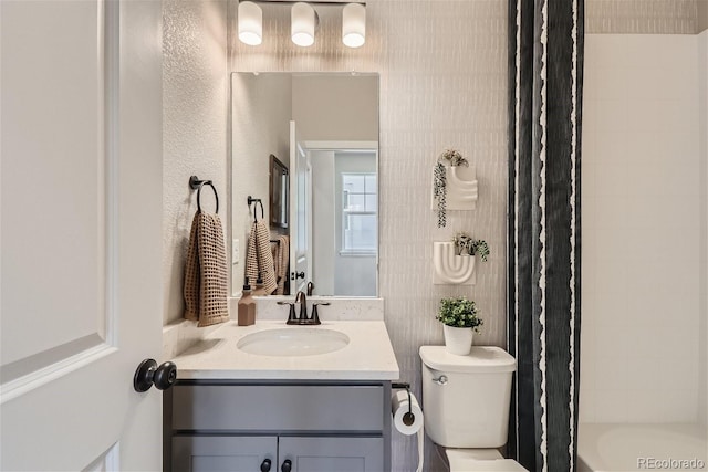 full bathroom with vanity, shower / bath combination with curtain, and toilet