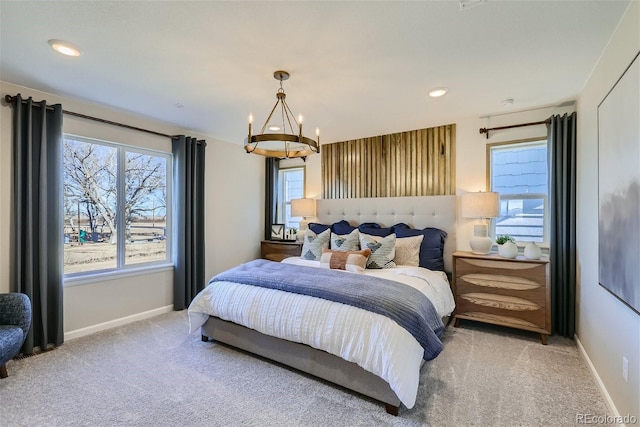 bedroom featuring carpet and an inviting chandelier