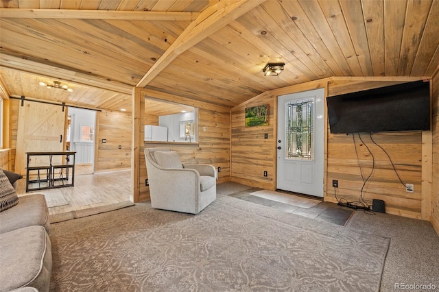 15535 S Elk Creek Rd, Pine, CO 80470 - carpeted living area featuring lofted ceiling, wood walls, wooden ceiling, and a barn door