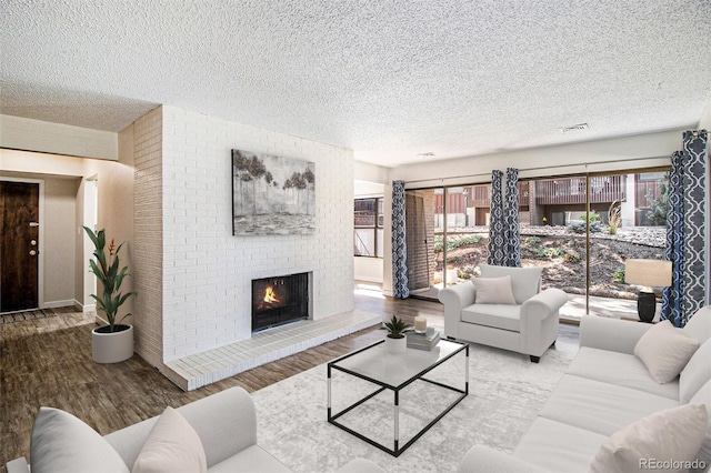 500 Manhattan Dr Unit B1, Boulder, CO 80303 - living room with a textured ceiling, wood finished floors, and a fireplace