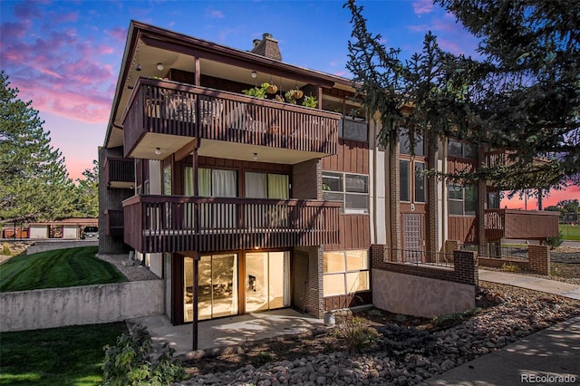 500 Manhattan Dr Unit B1, Boulder, CO 80303 - rear view of house featuring a balcony, a chimney, and a patio