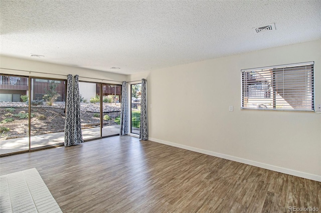 500 Manhattan Dr Unit B1, Boulder, CO 80303 - spare room with wood finished floors, baseboards, a textured ceiling, and healthy amount of natural light