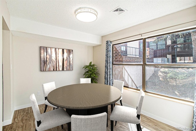 500 Manhattan Dr Unit B1, Boulder, CO 80303 - dining space featuring wood finished floors, baseboards, and a textured ceiling