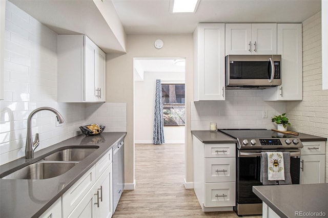500 Manhattan Dr Unit B1, Boulder, CO 80303 - kitchen with stainless steel appliances, dark countertops, a sink, and baseboards
