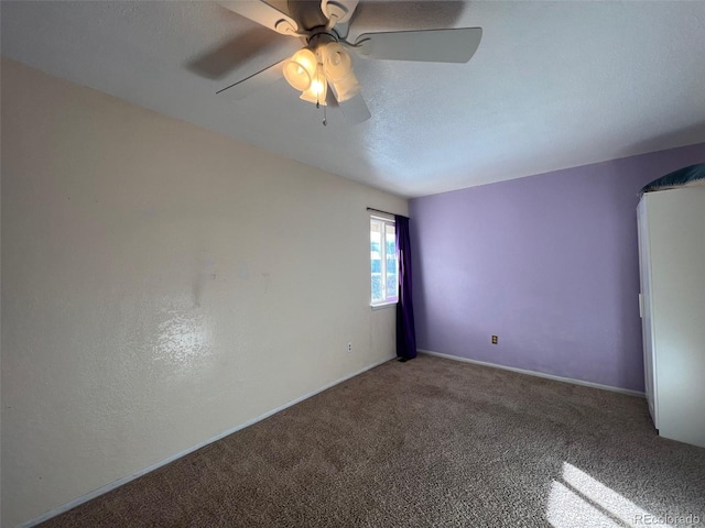 empty room with ceiling fan and carpet flooring