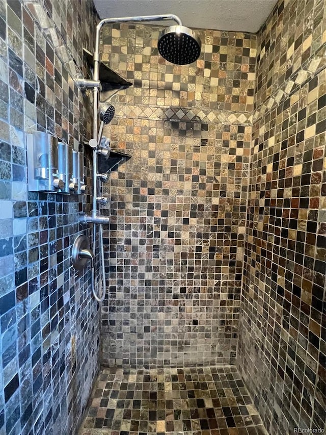 bathroom with a tile shower