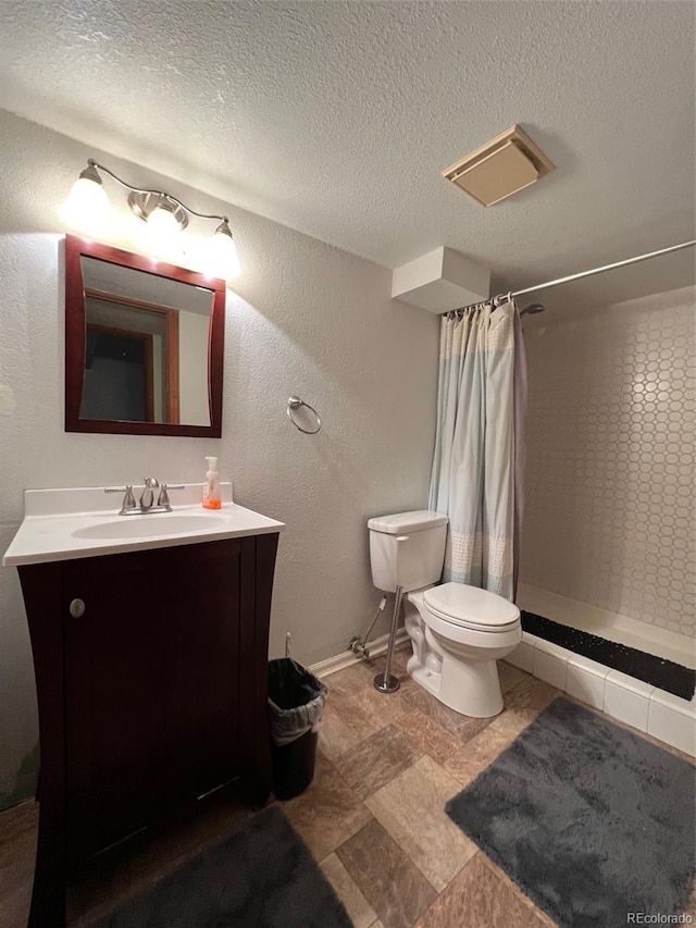 bathroom featuring a shower with curtain, toilet, a textured ceiling, large vanity, and tile floors