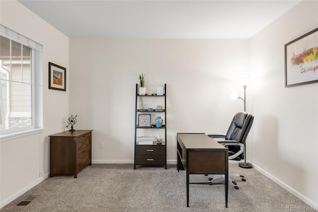 home office with baseboards, light colored carpet, and visible vents