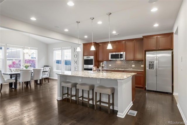 kitchen featuring baseboards, a sink, dark wood finished floors, and stainless steel appliances
