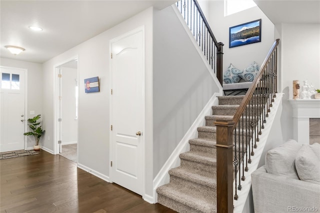 stairway featuring baseboards and wood finished floors