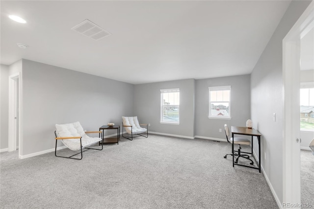 living area with baseboards, carpet flooring, and visible vents