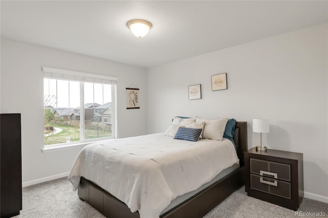 carpeted bedroom featuring baseboards