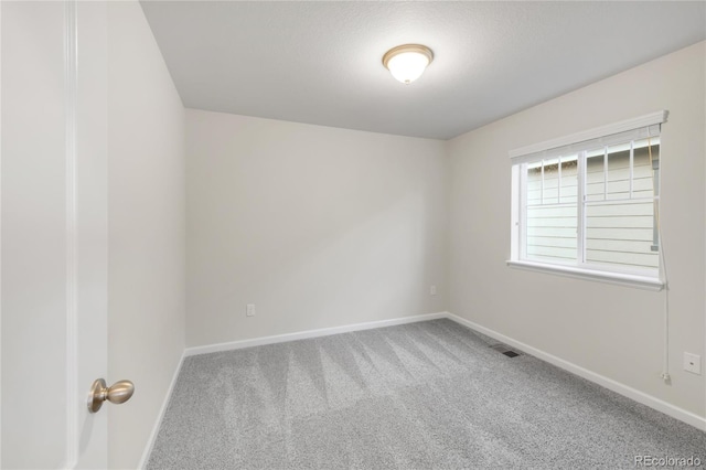 unfurnished room featuring baseboards, carpet, and visible vents