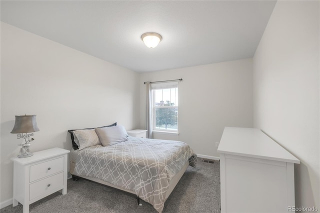 carpeted bedroom with visible vents and baseboards