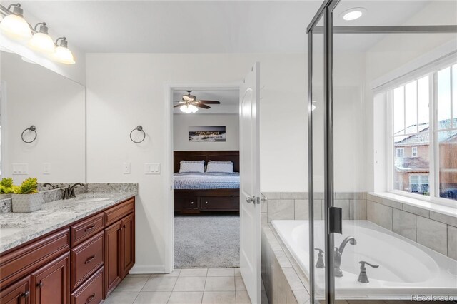 full bath featuring a bath, a wealth of natural light, ensuite bathroom, and tile patterned flooring