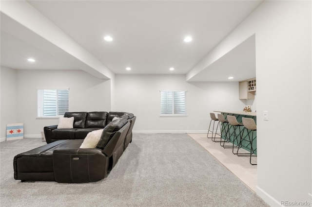 living room featuring a bar, recessed lighting, baseboards, and carpet floors