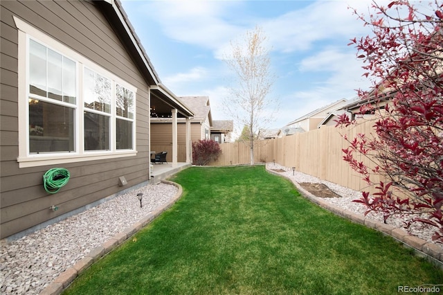 view of yard with a fenced backyard