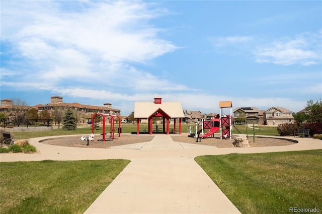 communal playground with a lawn and a gazebo