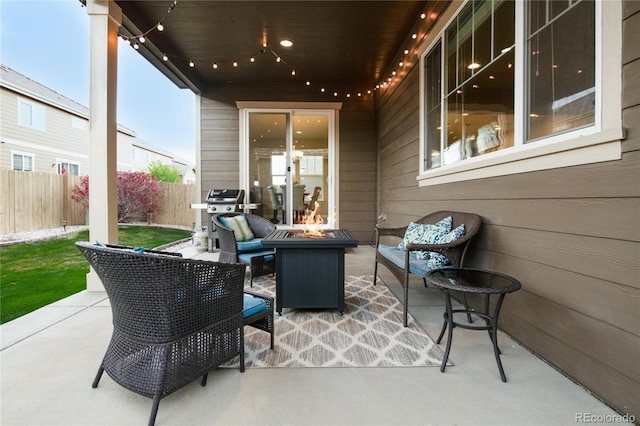 view of patio with fence, an outdoor living space with a fire pit, and grilling area